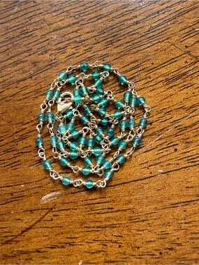 Delicate 14k yellow gold and green onyx station chain.